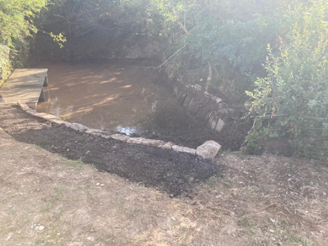 Pond with wooden decking at Holsome Park
