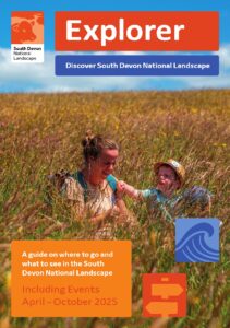 Explorer brochure front cover with image of young family in long grass