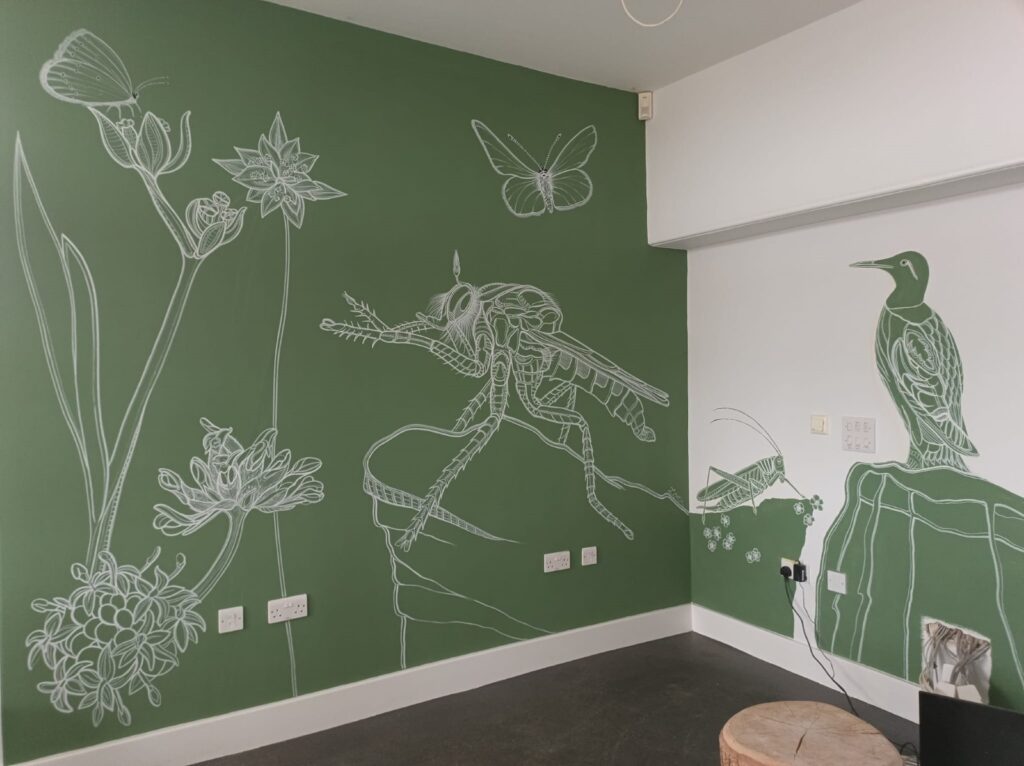 Mural of animal and plant species painted over two walls