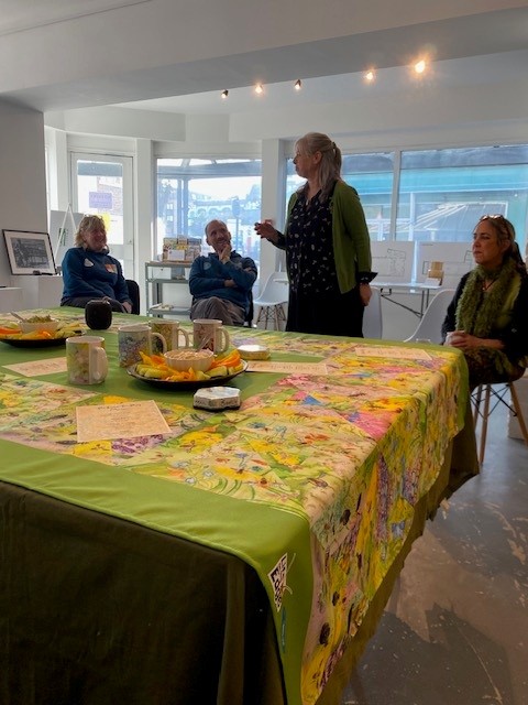 A table of beautifully laid-out finger-food and two women stood with plates of food